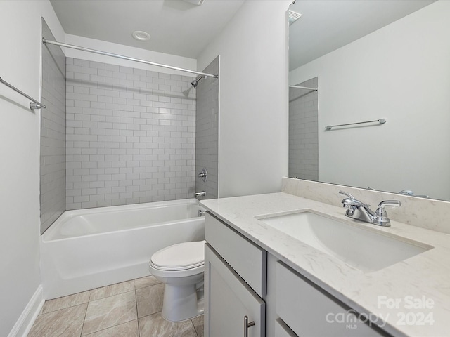 full bathroom with vanity, tiled shower / bath combo, toilet, and tile patterned floors