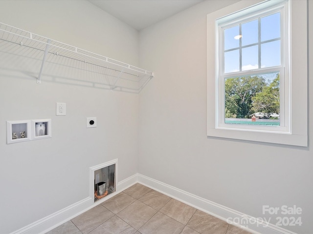 washroom with hookup for a washing machine, light tile patterned floors, and hookup for an electric dryer