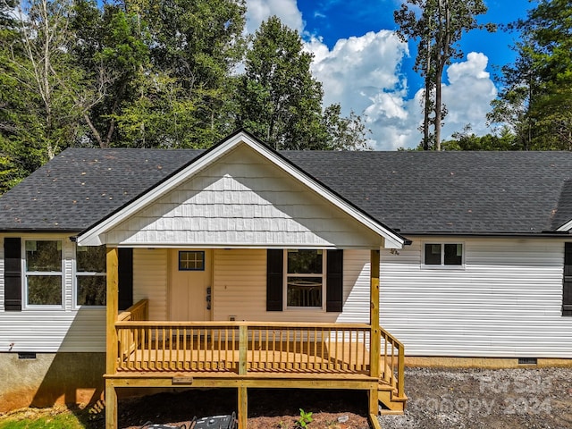 rear view of property with a wooden deck