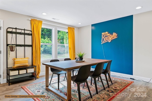 dining space with light hardwood / wood-style flooring