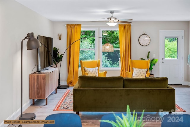 living room with ceiling fan and wood-type flooring