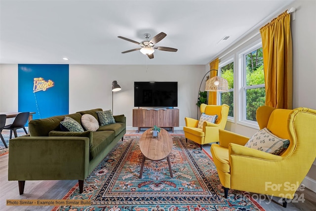 living room featuring hardwood / wood-style floors and ceiling fan