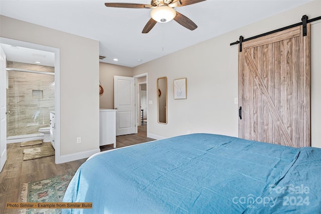 bedroom featuring a barn door, ceiling fan, wood-type flooring, and connected bathroom