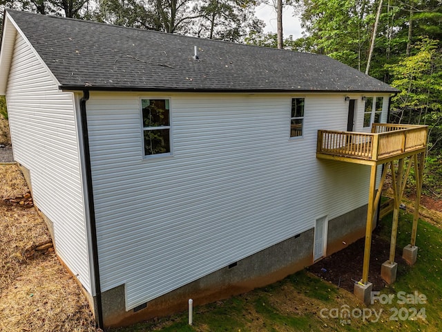 view of home's exterior with a wooden deck