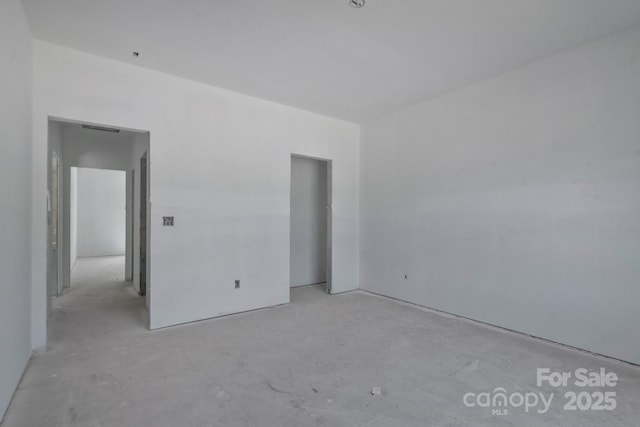 unfurnished room with concrete flooring