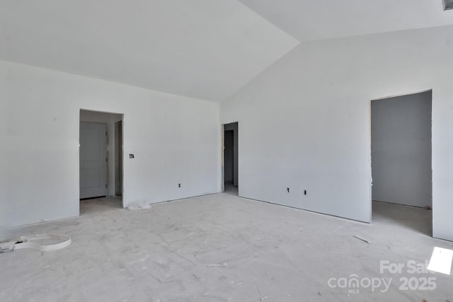 unfurnished room featuring high vaulted ceiling