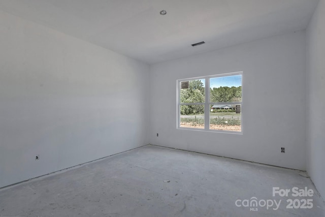unfurnished room with visible vents and unfinished concrete floors