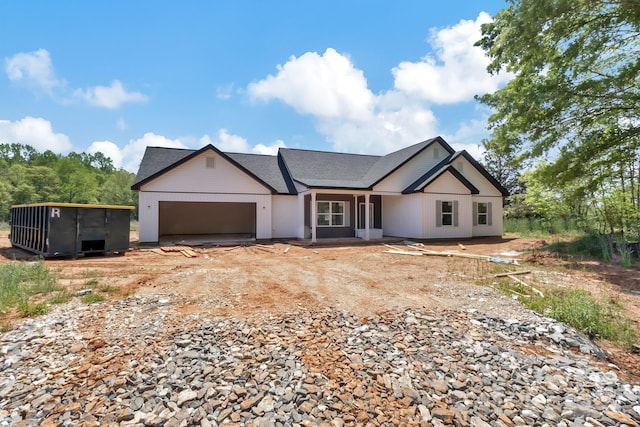 view of front facade featuring an attached garage and dirt driveway