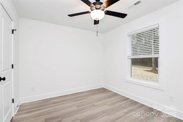 interior space with baseboards, light wood-style floors, and visible vents