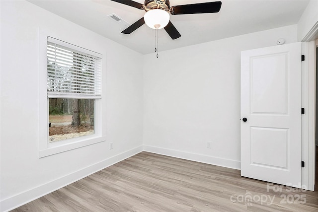 empty room with ceiling fan, baseboards, light wood-style floors, and visible vents