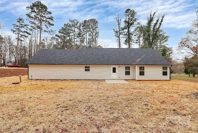 back of property featuring a patio area and a shingled roof