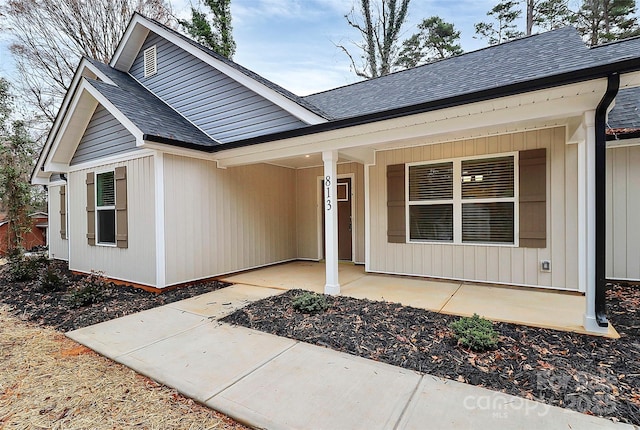 view of front of property with roof with shingles and a porch