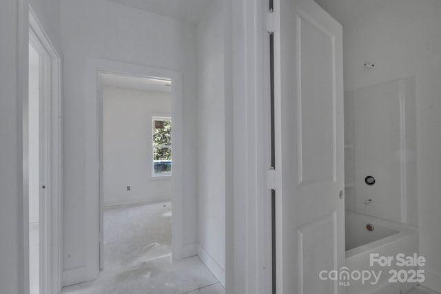 corridor featuring baseboards