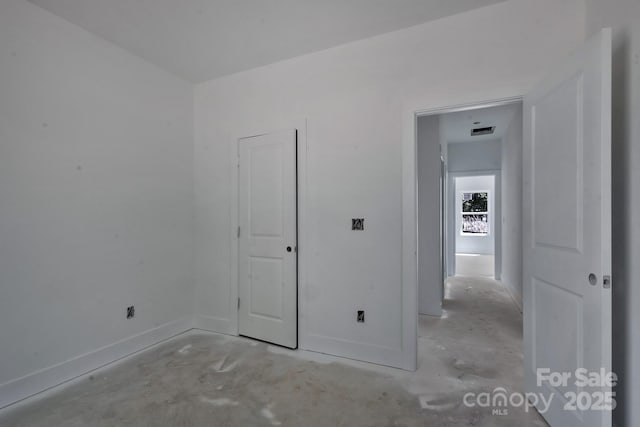 interior space with visible vents, baseboards, and concrete floors