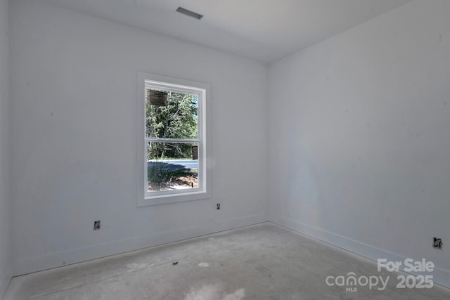 unfurnished room featuring visible vents, baseboards, and concrete floors