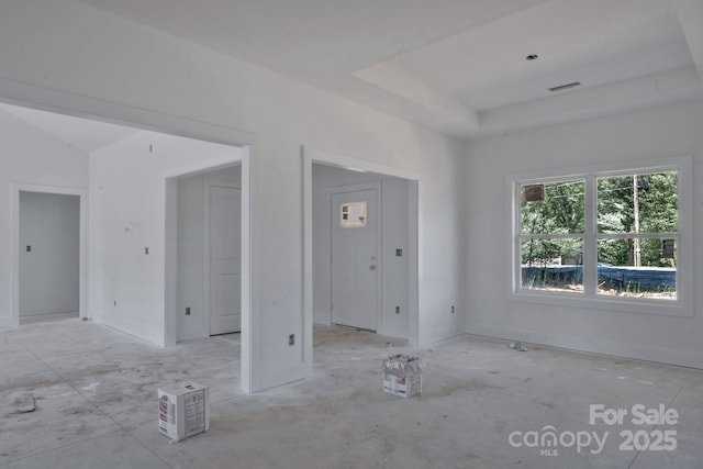 interior space featuring a tray ceiling and visible vents