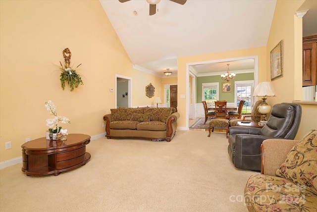 carpeted living room with ceiling fan with notable chandelier, ornamental molding, and vaulted ceiling