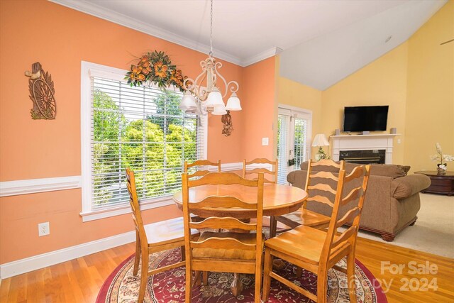 dining room featuring a notable chandelier, crown molding, and hardwood / wood-style floors