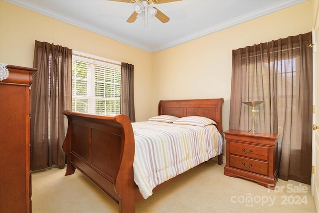 carpeted bedroom featuring ceiling fan and ornamental molding