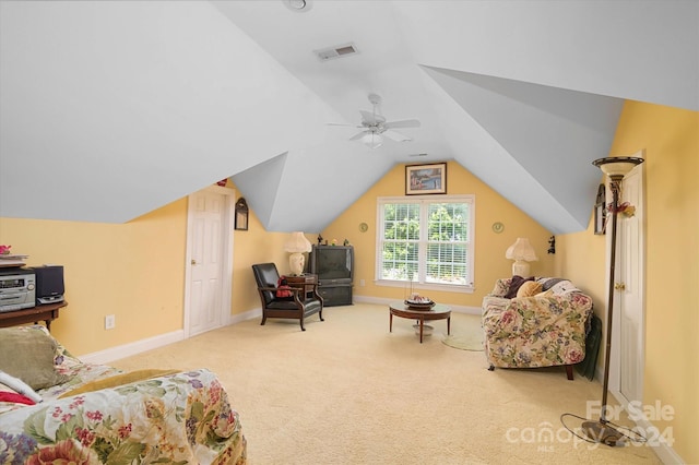 living area with ceiling fan, carpet, and lofted ceiling