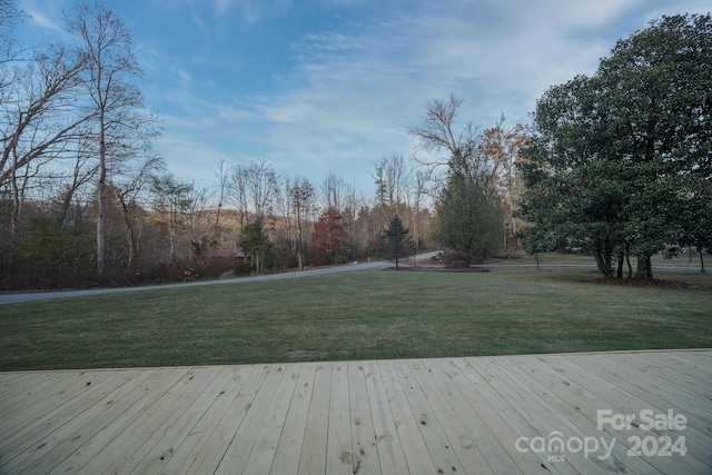 wooden deck featuring a yard