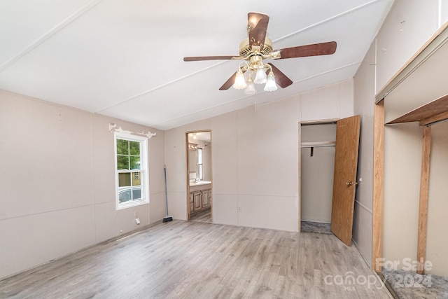 unfurnished bedroom with lofted ceiling, light wood-type flooring, ensuite bathroom, and ceiling fan