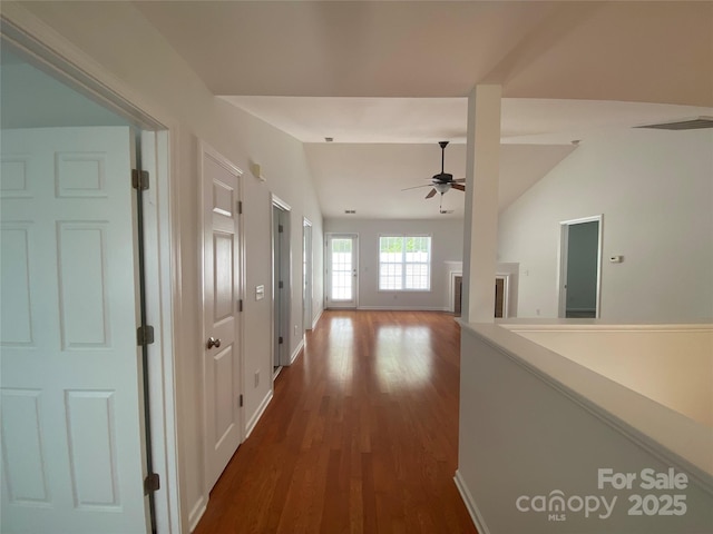 hall featuring lofted ceiling and hardwood / wood-style flooring