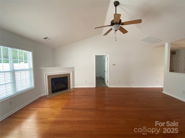 unfurnished living room with lofted ceiling, hardwood / wood-style flooring, a fireplace, and ceiling fan