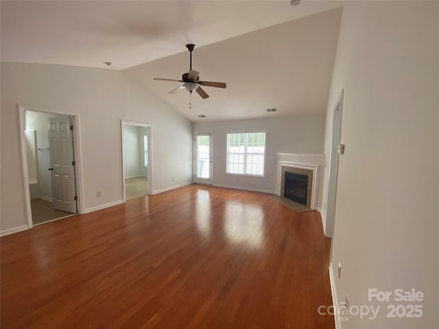 unfurnished living room with vaulted ceiling, hardwood / wood-style floors, and ceiling fan