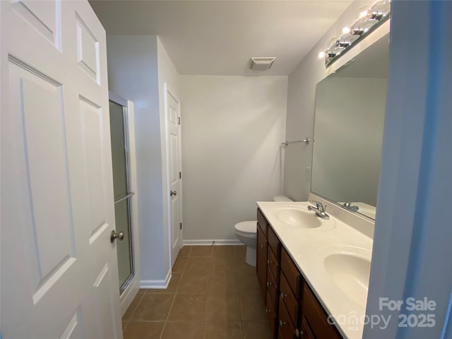 bathroom featuring an enclosed shower, vanity, tile patterned floors, and toilet