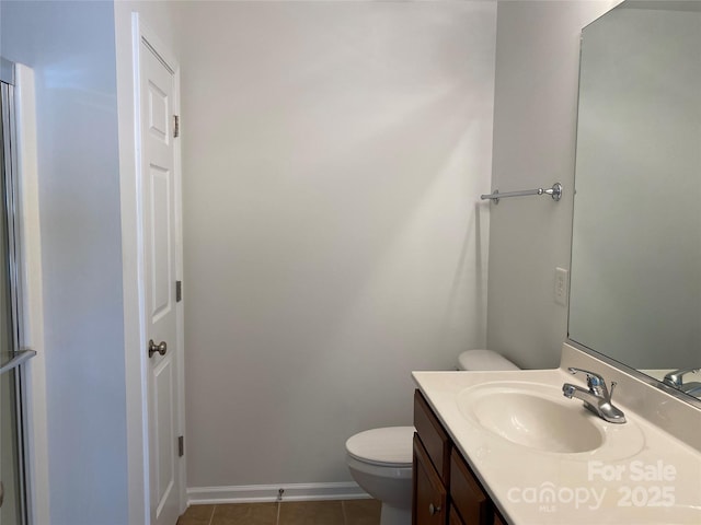 bathroom featuring tile patterned floors, toilet, and vanity