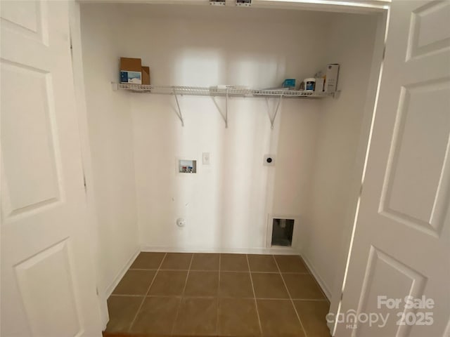 clothes washing area featuring washer hookup, electric dryer hookup, dark tile patterned floors, and gas dryer hookup