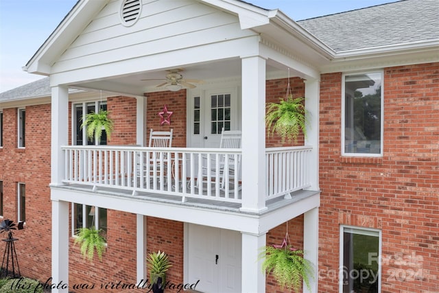 rear view of house featuring a balcony and ceiling fan