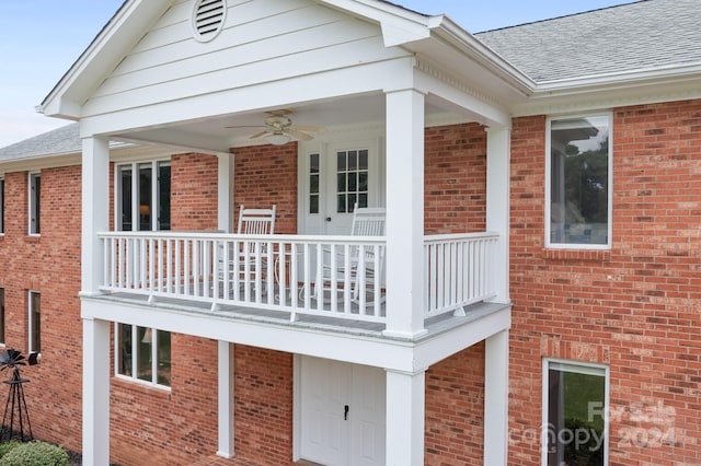 back of house featuring ceiling fan and a balcony