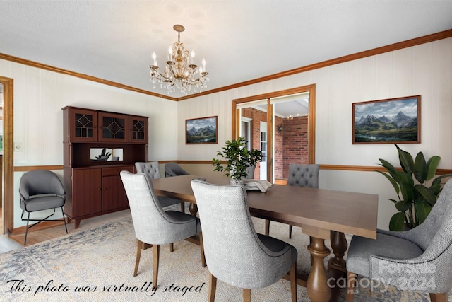 dining room with crown molding, light hardwood / wood-style floors, and a notable chandelier