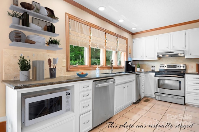 kitchen with backsplash, sink, white cabinetry, stainless steel appliances, and light tile patterned floors