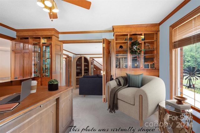 carpeted living room with ceiling fan and ornamental molding