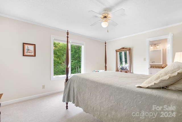 carpeted bedroom featuring ceiling fan, crown molding, connected bathroom, and a textured ceiling