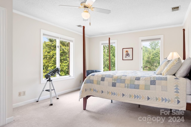 bedroom with light carpet, ceiling fan, crown molding, and a textured ceiling