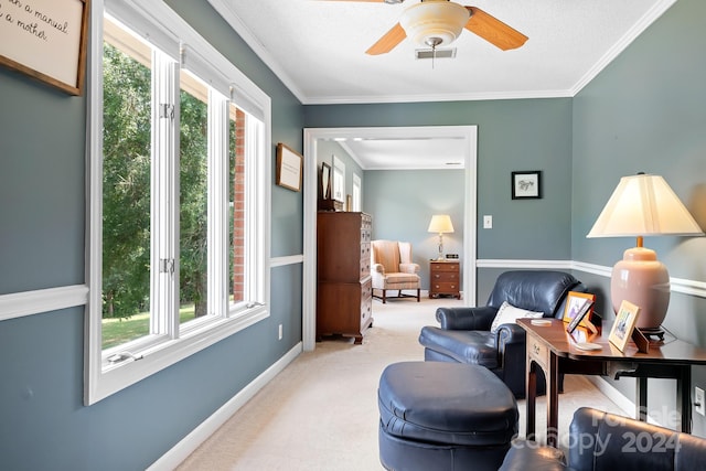 living area featuring ceiling fan, crown molding, and light colored carpet