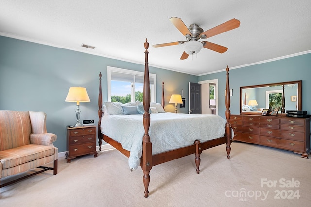 bedroom featuring ceiling fan, crown molding, light carpet, and a textured ceiling