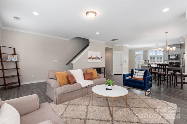 living room featuring crown molding, dark hardwood / wood-style floors, and a chandelier