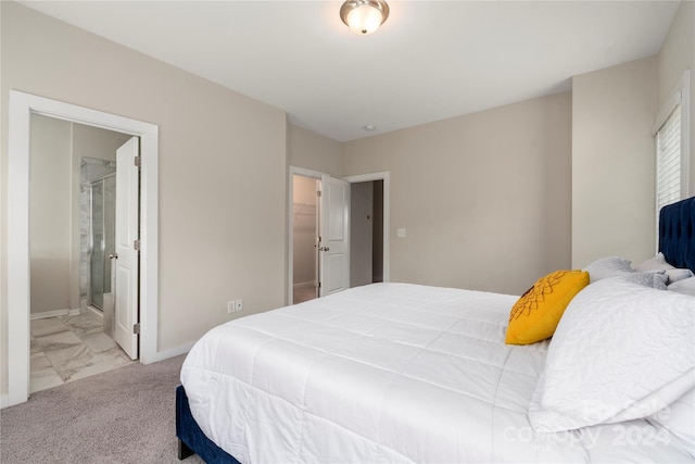 bedroom with light carpet and ensuite bath