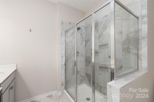 bathroom featuring vanity and a shower with shower door