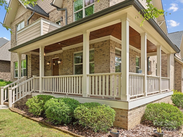 view of side of home with a porch