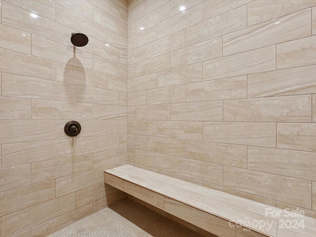 bathroom with a tile shower