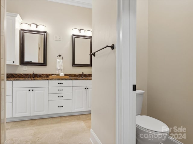 bathroom featuring vanity, toilet, and ornamental molding