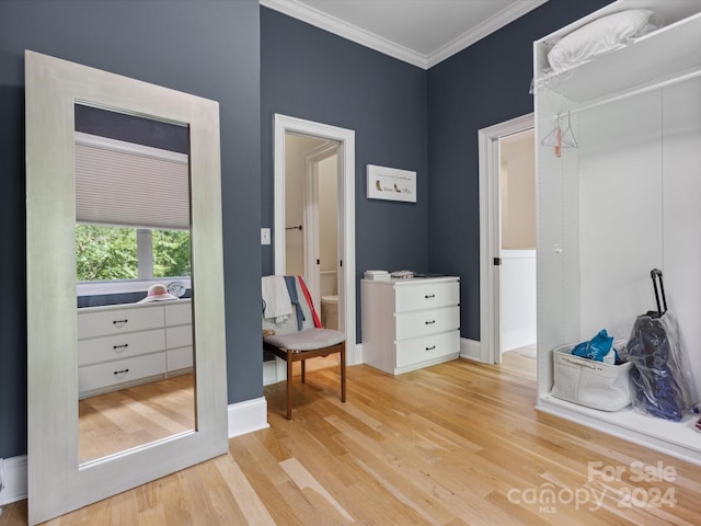 interior space with light hardwood / wood-style floors and crown molding