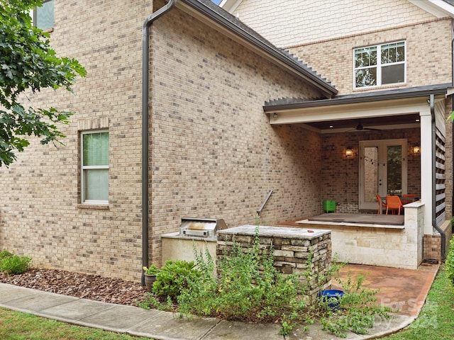 view of side of property featuring exterior kitchen