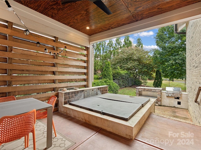 view of patio with area for grilling and ceiling fan